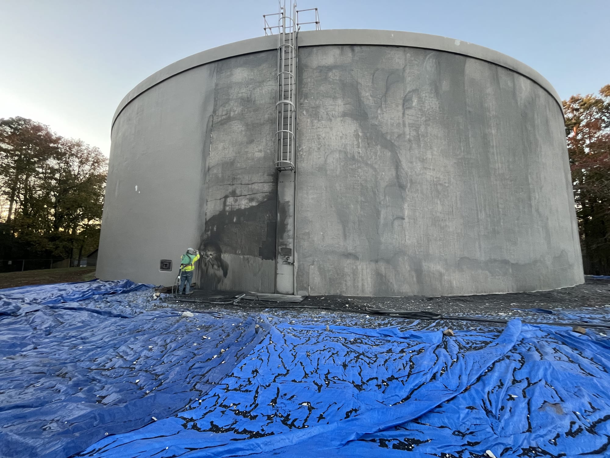 Municipal water storage tank being sandblasted to remove old coating by McConnell Sandblasting
